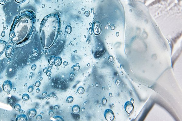 Macro shot of clear cosmetic gel with air bubbles showing texture and clarity.